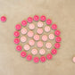Wooden circle mandala pieces in various shades of pink are arranged in a circle pattern they are grouped by shade.