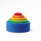 Wooden stacking bowls are nested inside each other.  They are in bright rainbow colours