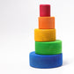 5 wooden rainbow coloured circular bowls are stacked to form a tower.